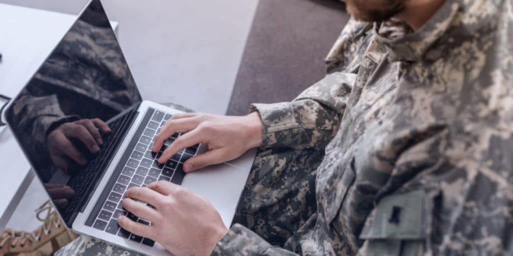 cyber soldier working with laptop